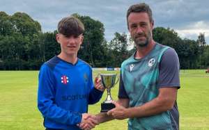 Scotland captain James Stronach gets the U17 Celtic Cup from Nigel Jones