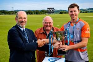 Mark Tonge gets the trophy from Brian Kelleher and Ger Siggins